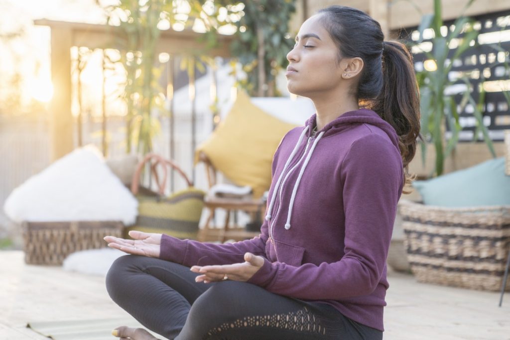 Woman sitting crossed-legged in the yoga position