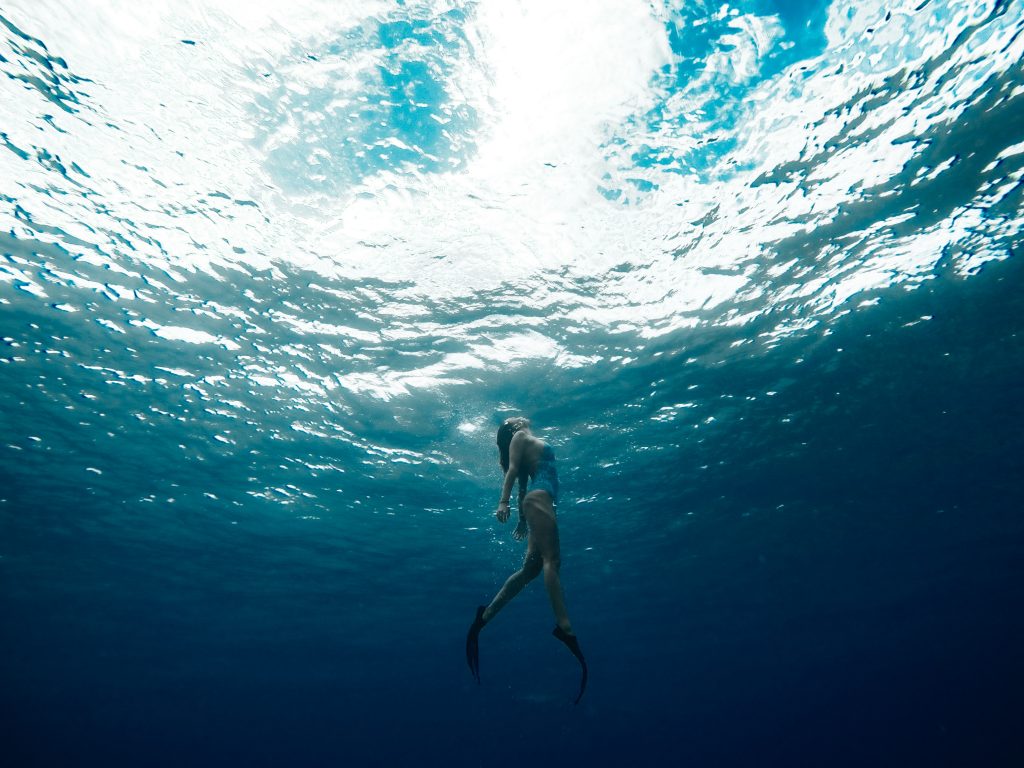 Woman swimming in the water up to the surface